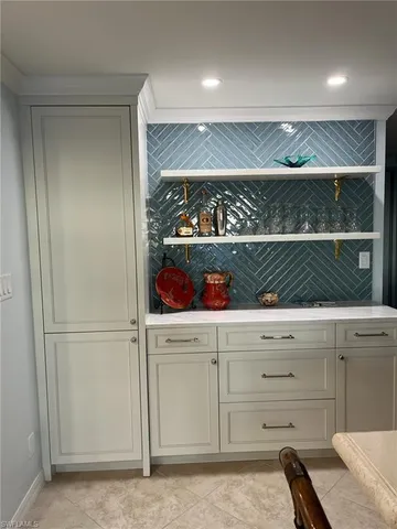 a kitchen with a refrigerator and lots of wooden cabinets