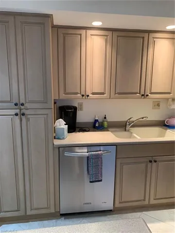 a room with a sink cabinets and a window