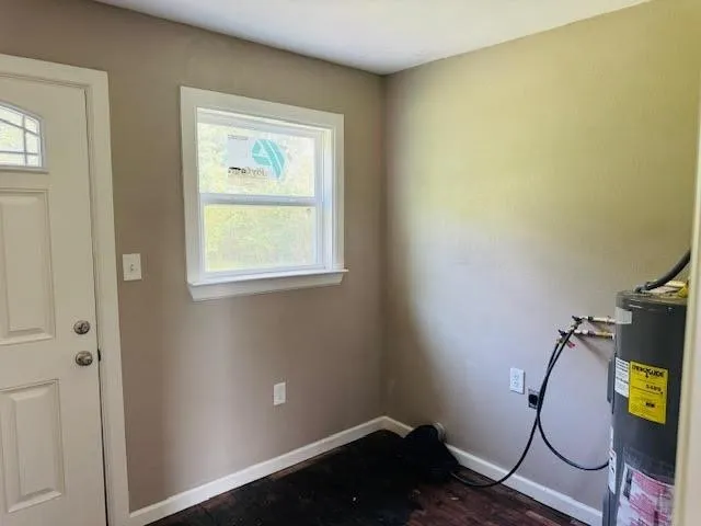 a room with gym equipment and wooden floor