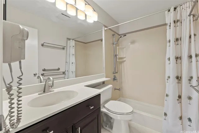 a bathroom with a sink toilet vanity and shower