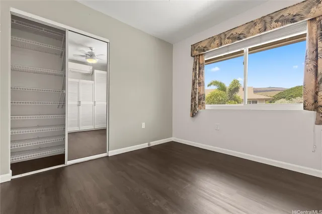 an empty room with wooden floor and a window