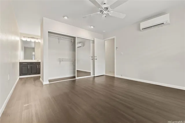 an empty room with wooden floor and mirror