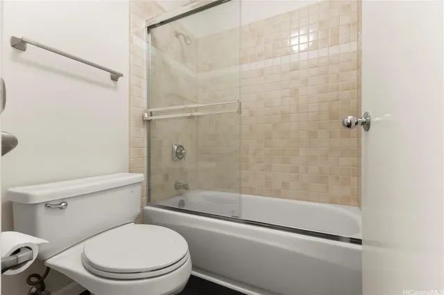 a white toilet and shower