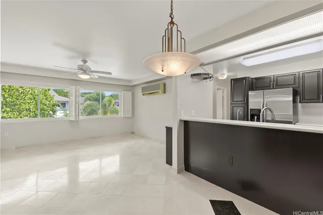 a view of a kitchen with a sink and chandelier