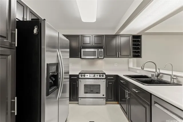 a kitchen with stainless steel appliances granite countertop a refrigerator and a sink