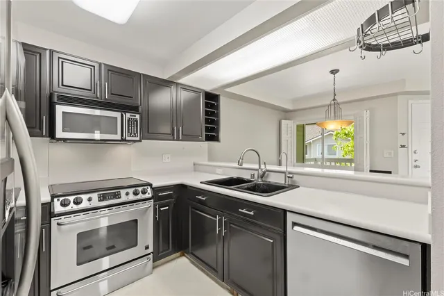 a kitchen with stainless steel appliances granite countertop a sink stove oven a microwave and cabinets
