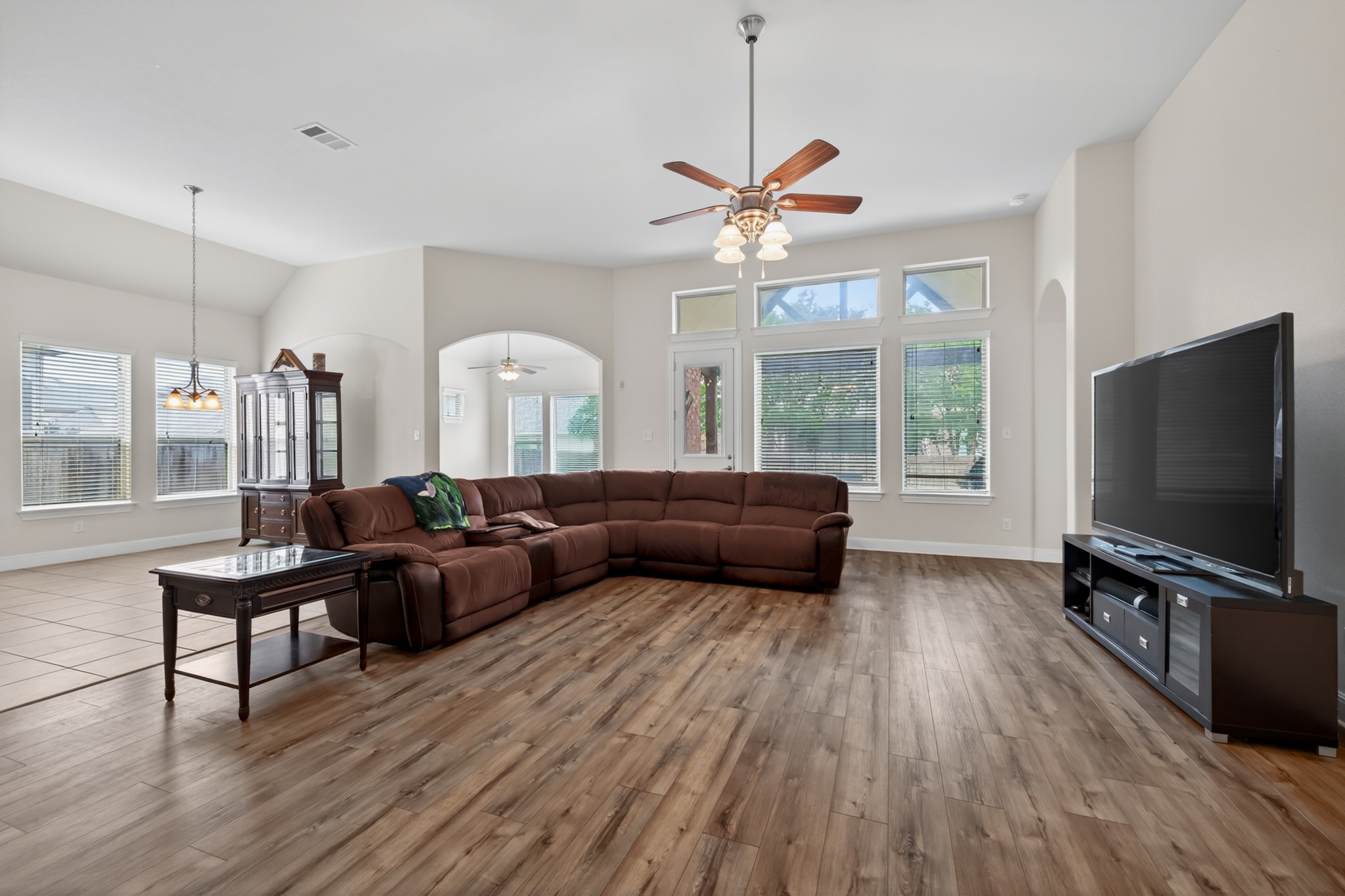 1017 Tabernash Leander, TX 78641 - Photo 17 of 38 Spacious living area featuring wood-finish flooring, vaulted ceilings, and a ceiling fan with integrated lighting