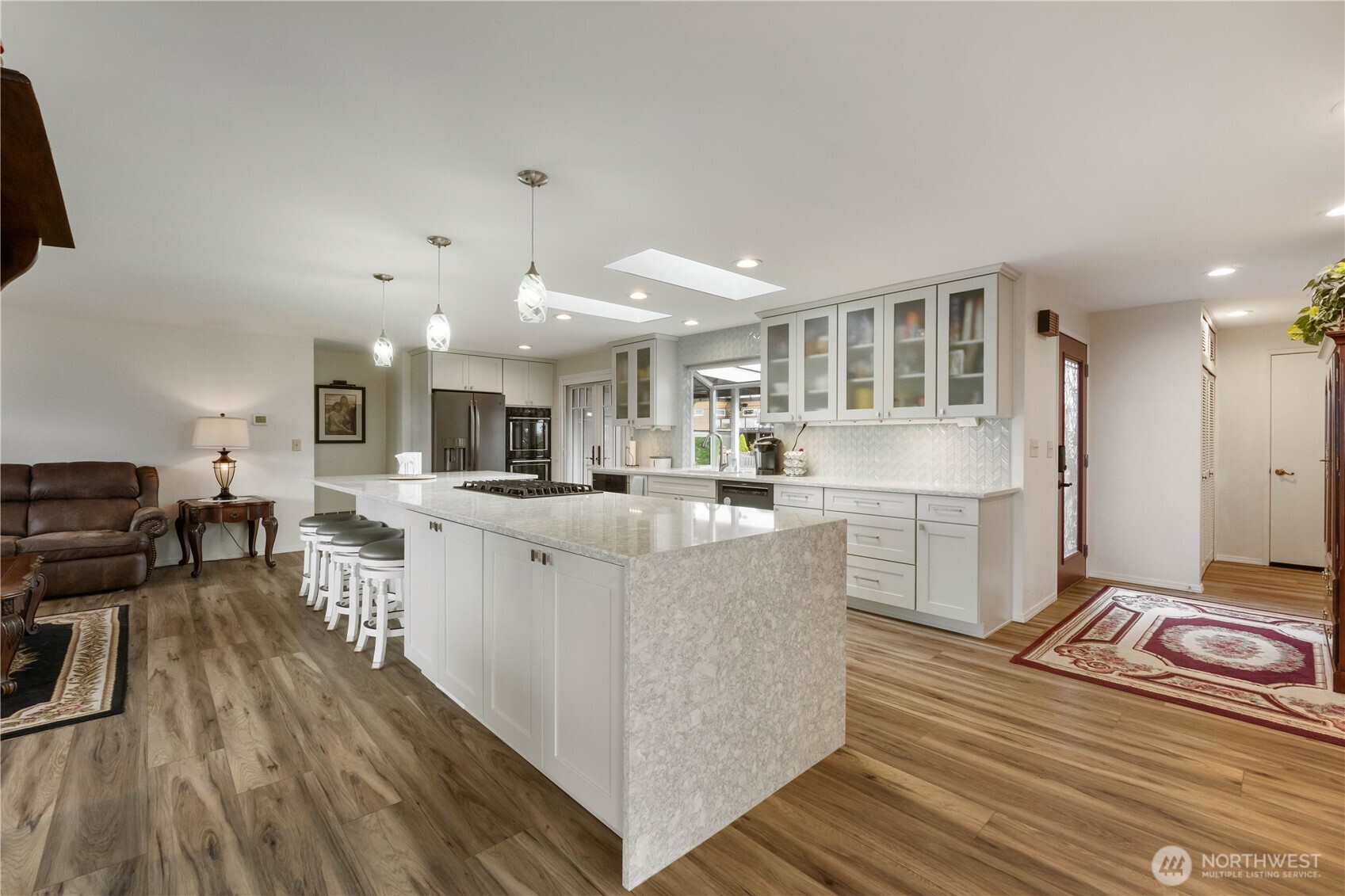 4911 Mildred Street Tacoma, WA 98407 - Photo 11 of 40 a living room with kitchen island stainless steel appliances furniture a large window and a counter space