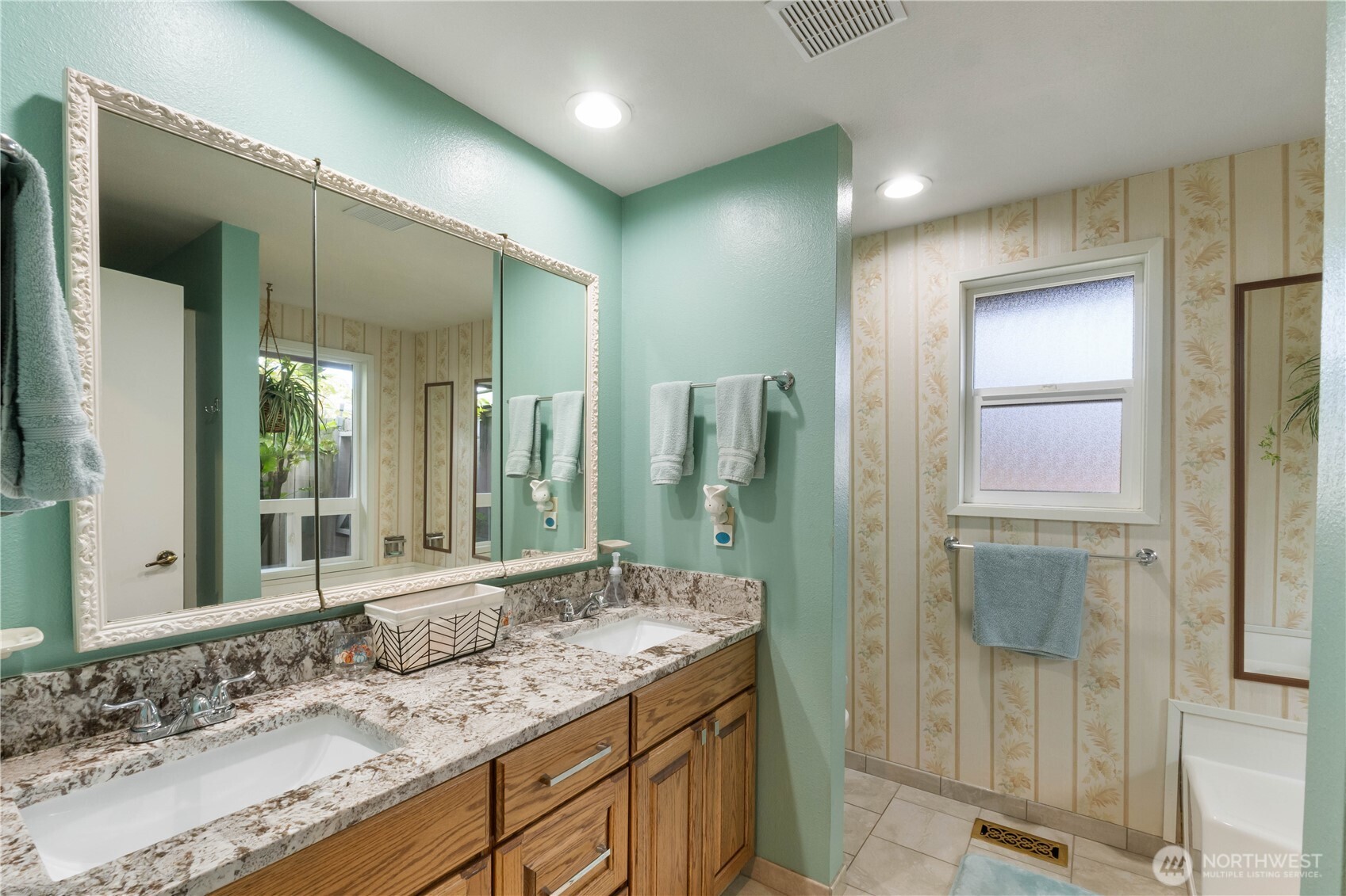 4911 Mildred Street Tacoma, WA 98407 - Photo 20 of 40 a bathroom with a granite countertop sink and a mirror
