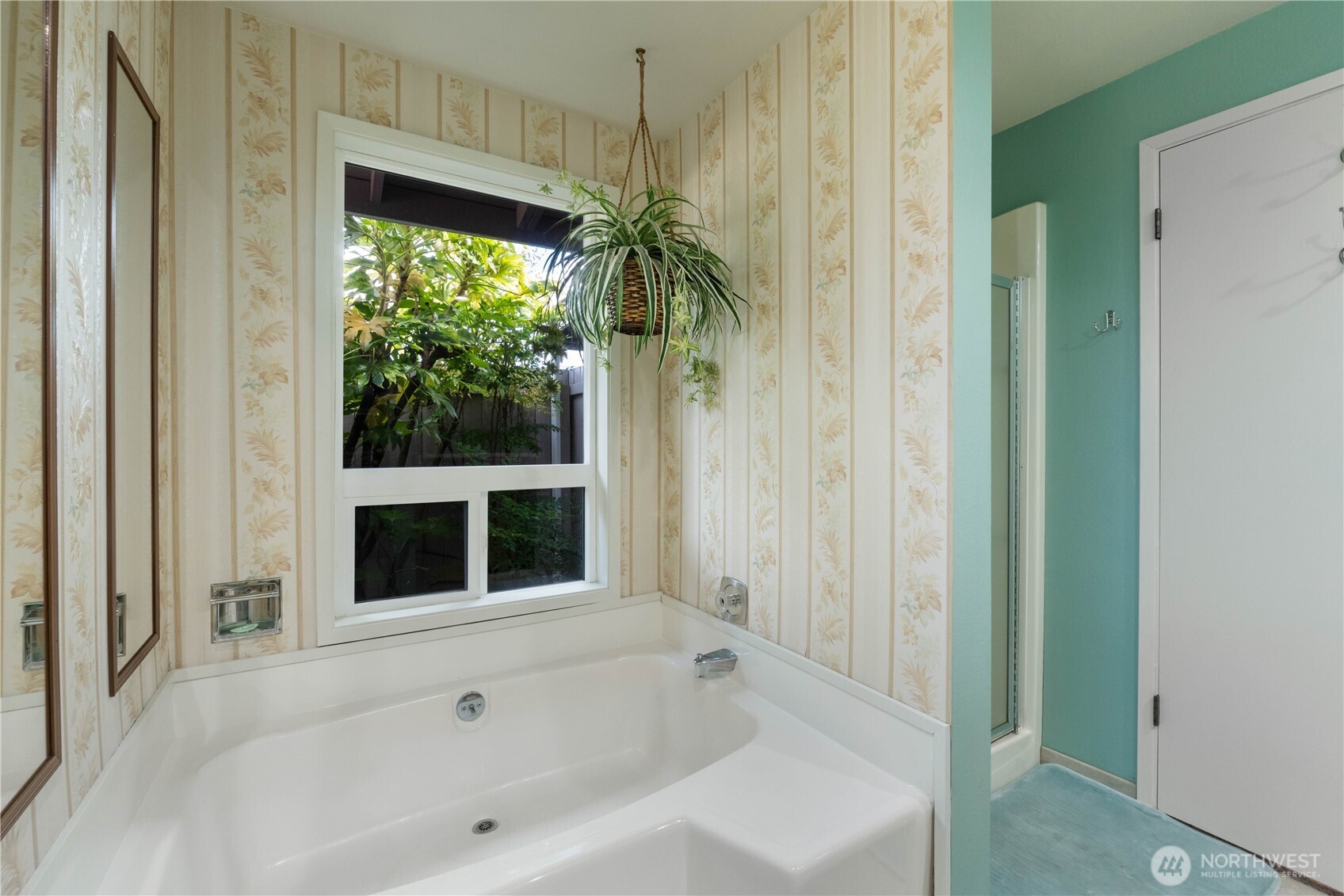 4911 Mildred Street Tacoma, WA 98407 - Photo 21 of 40 a bathroom with bathtub and window