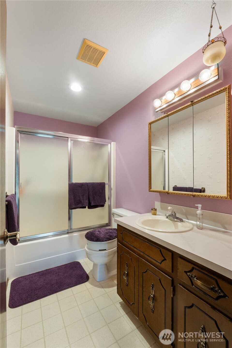 4911 Mildred Street Tacoma, WA 98407 - Photo 27 of 40 a spacious bathroom with a double vanity sink a large mirror and a shower