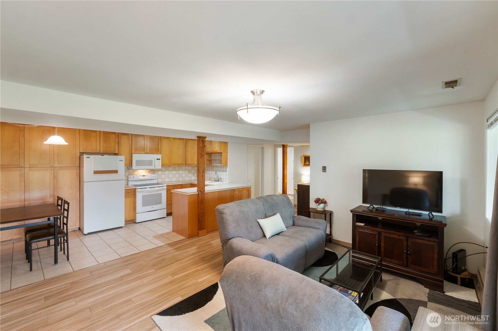 4911 Mildred Street Tacoma, WA 98407 - Photo 30 of 40 a living room with furniture and a flat screen tv