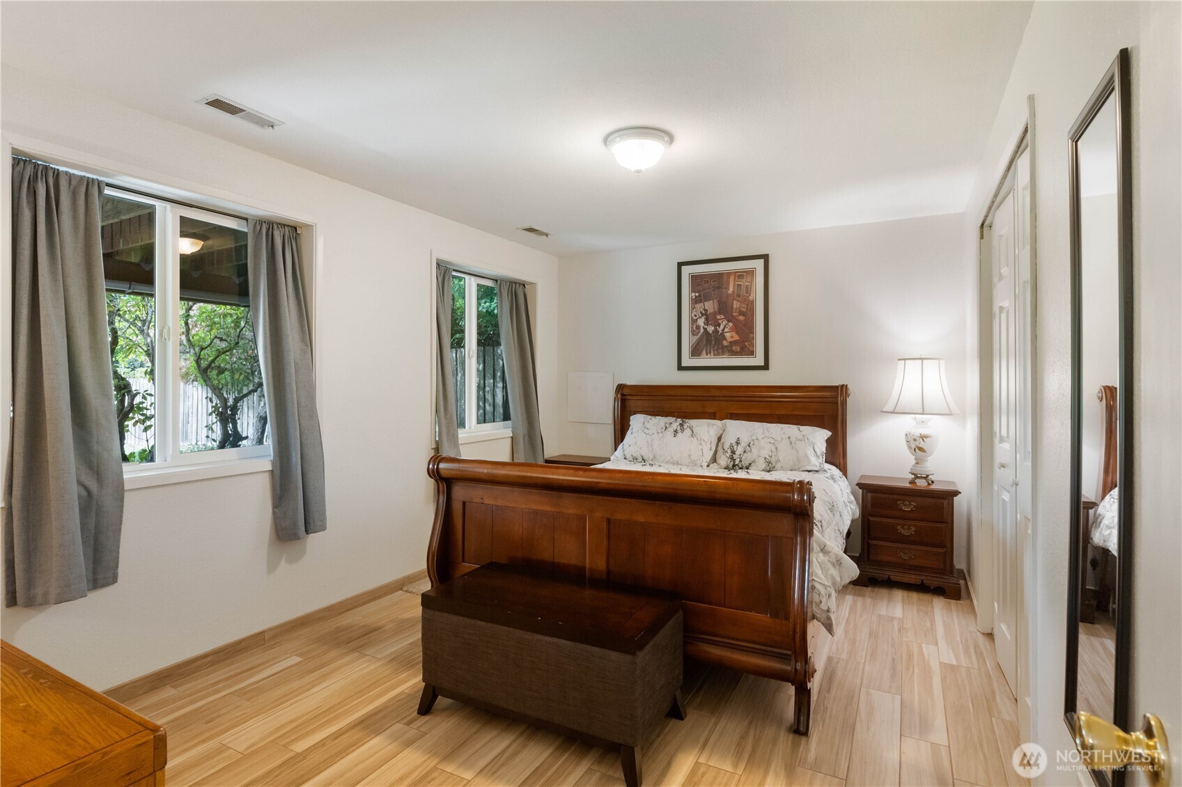 4911 Mildred Street Tacoma, WA 98407 - Photo 31 of 40 a bedroom with a bed and wooden floor