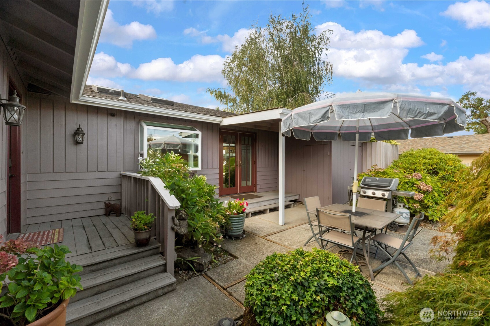 4911 Mildred Street Tacoma, WA 98407 - Photo 9 of 40 a view of a house with sitting area and garden