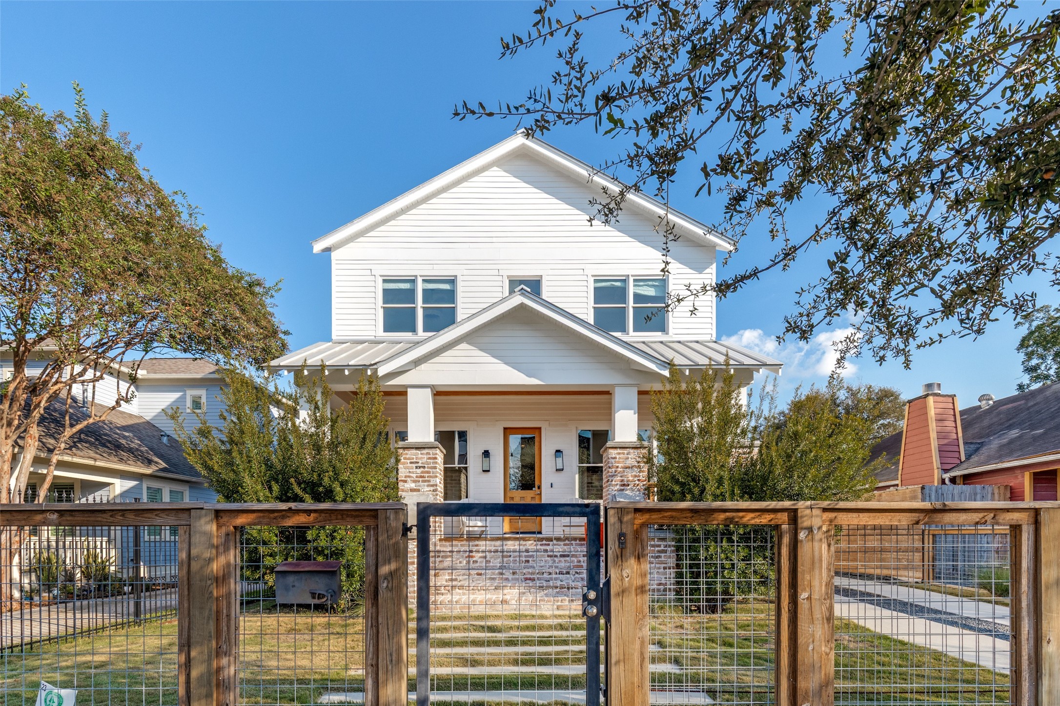 a view of a house with wooden fence