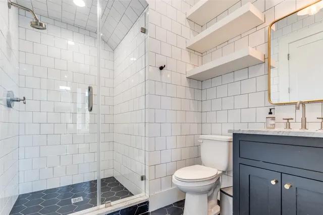a bathroom with a sink toilet and shower