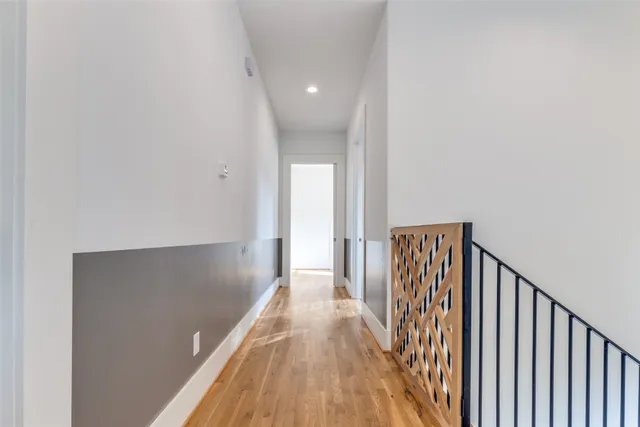 a view of a hallway with wooden floor