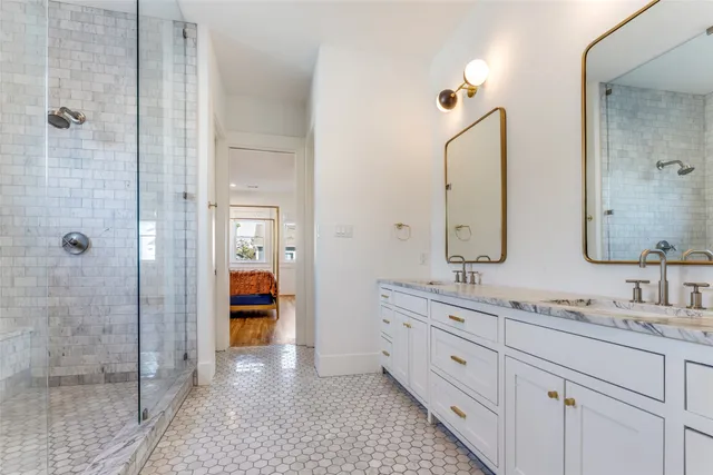 a spacious bathroom with double sink and shower