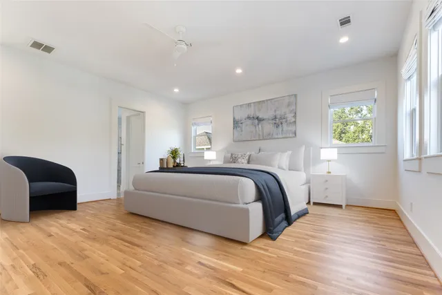 a spacious bedroom with a bed and a couch