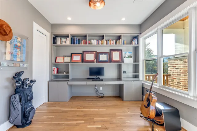 a view of a workspace with furniture and a bookshelf