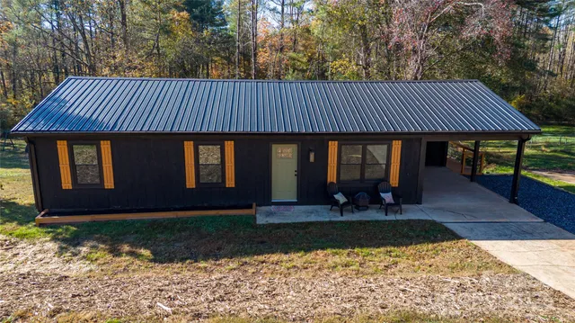 a view of a house with backyard porch and sitting area