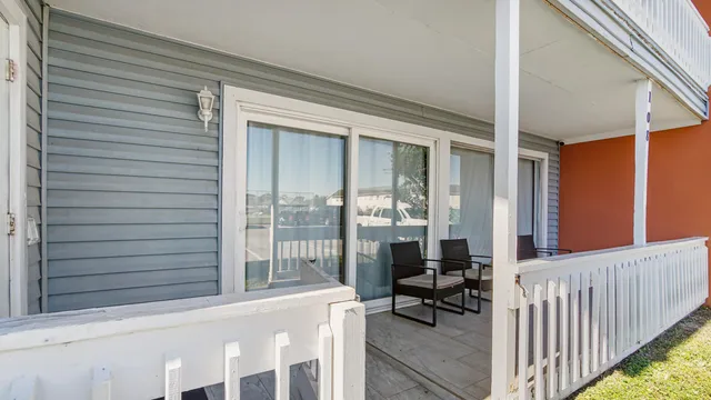 a front view of a house with a yard and potted plants