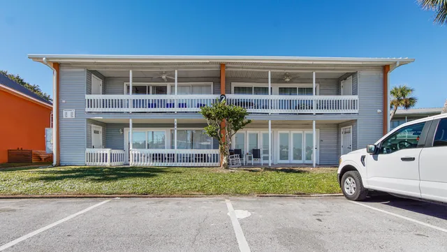 a aerial view of a house with swimming pool and large trees