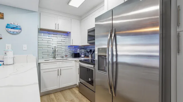 a kitchen with a refrigerator and a sink