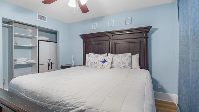 a large bed sitting in a bedroom next to a window