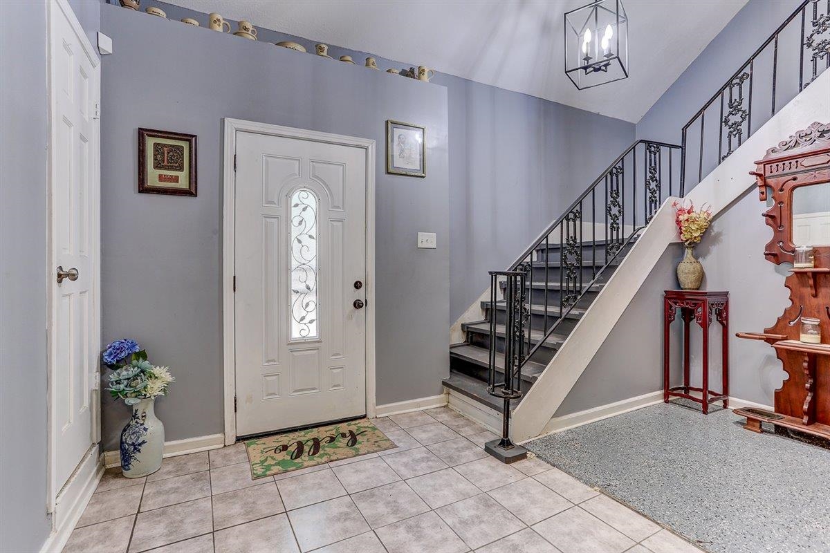 3700 Lakeview Road Memphis, TN 38116 - Photo 10 of 40 Entryway with light tile patterned floors and a chandelier