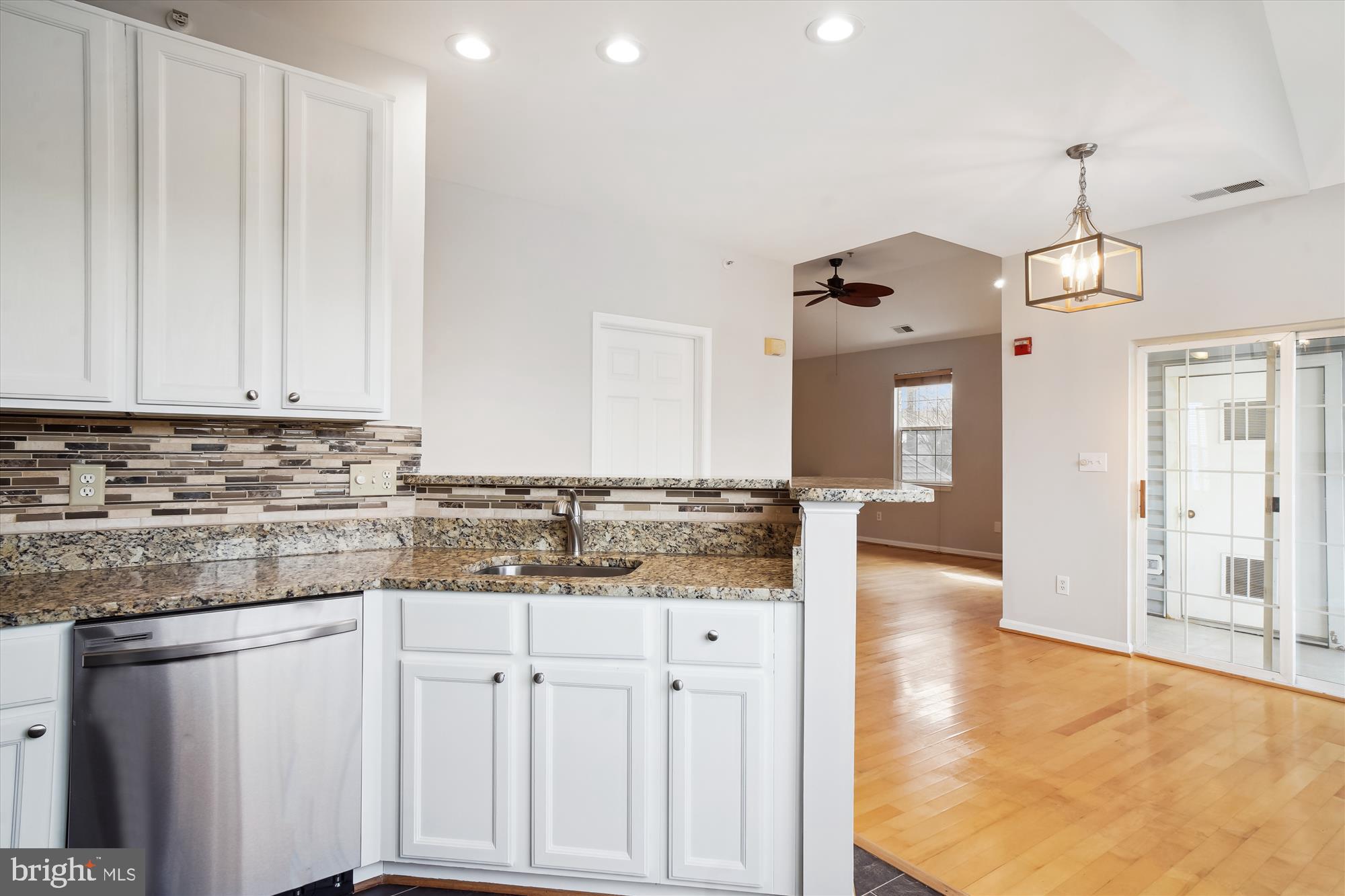 12712 Found Stone Road, Unit 4206 Germantown, MD 20876 - Photo 13 of 58 a kitchen with granite countertop a sink and cabinets