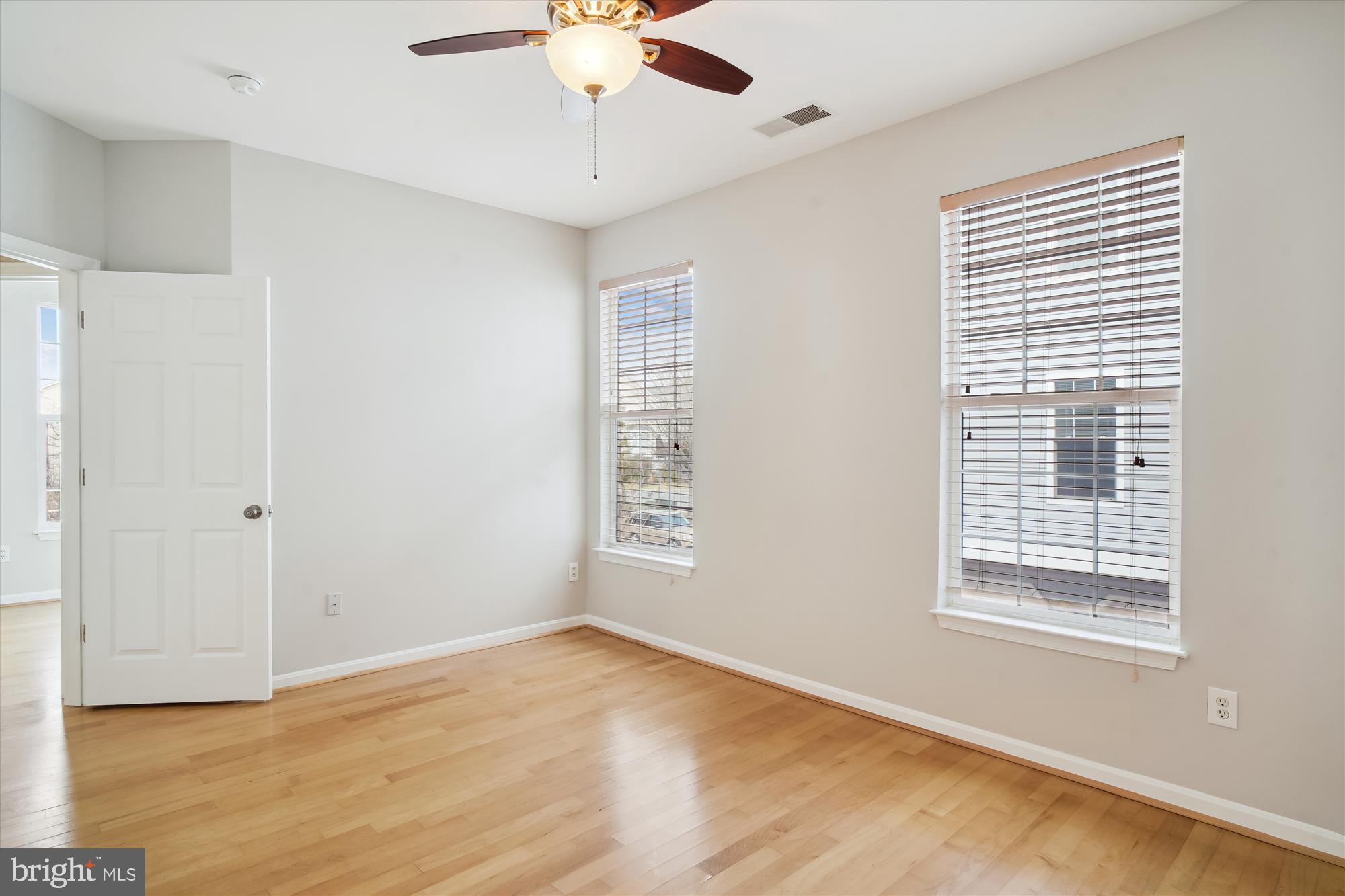 12712 Found Stone Road, Unit 4206 Germantown, MD 20876 - Photo 16 of 58 a view of an empty room with a window and wooden floor