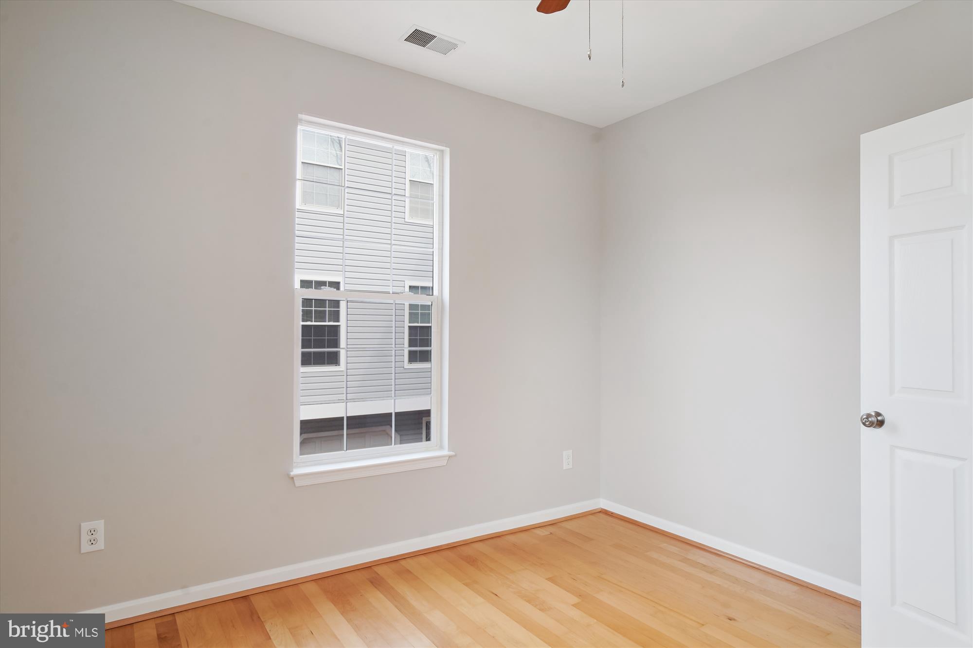 12712 Found Stone Road, Unit 4206 Germantown, MD 20876 - Photo 19 of 58 a view of an empty room with wooden floor and a window