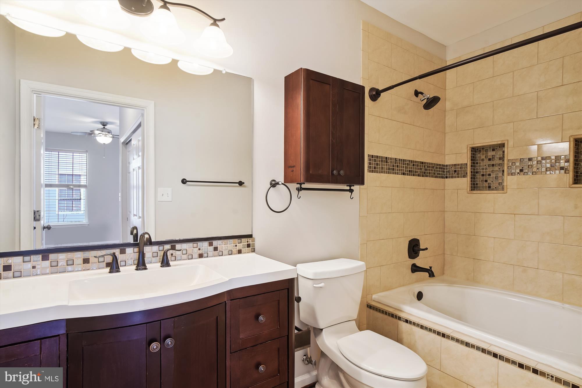 12712 Found Stone Road, Unit 4206 Germantown, MD 20876 - Photo 22 of 58 a bathroom with a bathtub shower sink mirror vanity and toilet