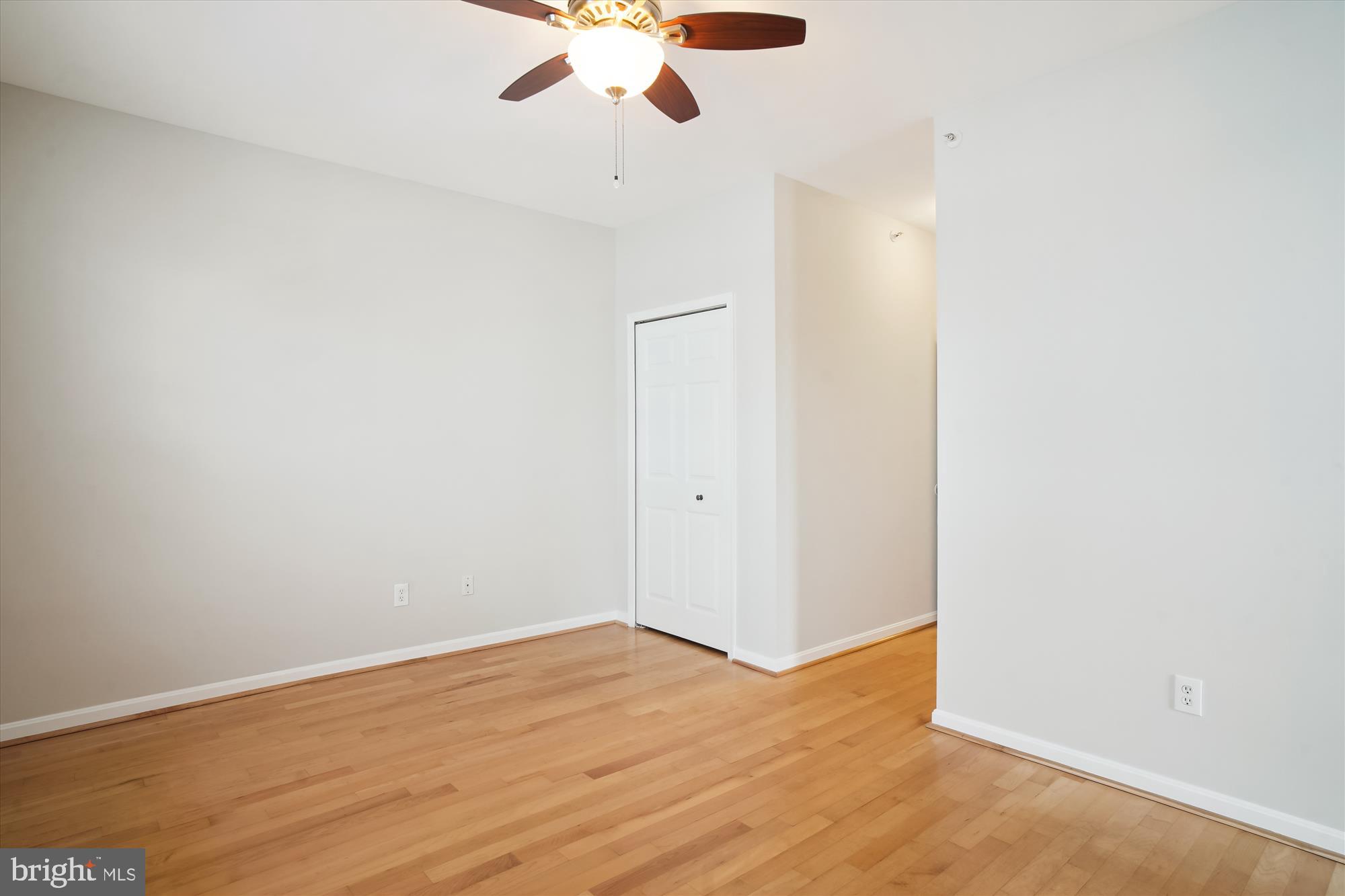 12712 Found Stone Road, Unit 4206 Germantown, MD 20876 - Photo 23 of 58 an empty room with wooden floor fan and windows