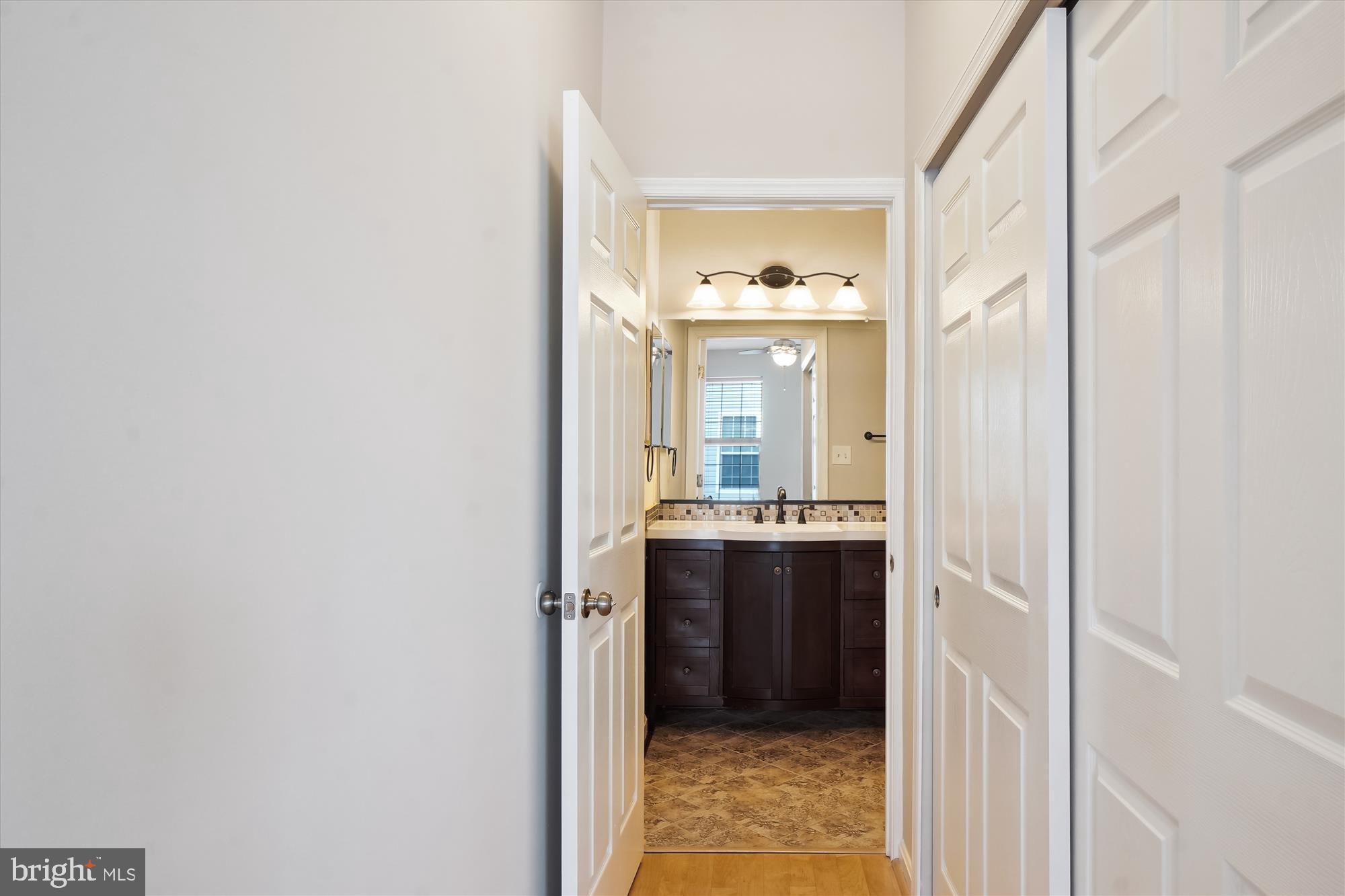 12712 Found Stone Road, Unit 4206 Germantown, MD 20876 - Photo 26 of 58 a bathroom with a double vanity sink and mirror