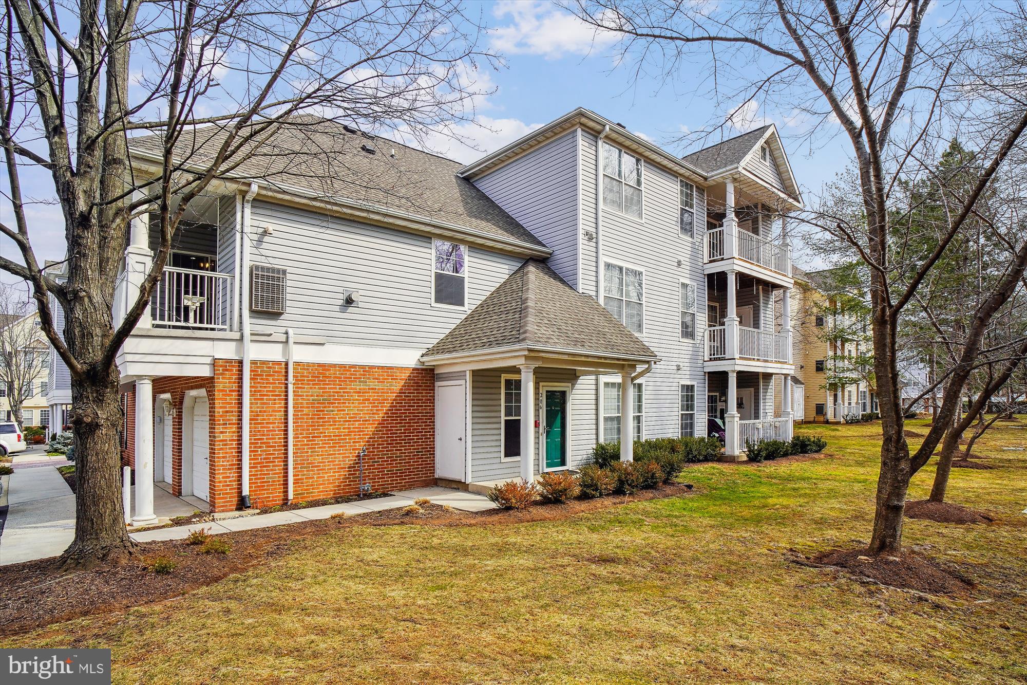 12712 Found Stone Road, Unit 4206 Germantown, MD 20876 - Photo 38 of 58 a view of a white house with a large windows and large trees