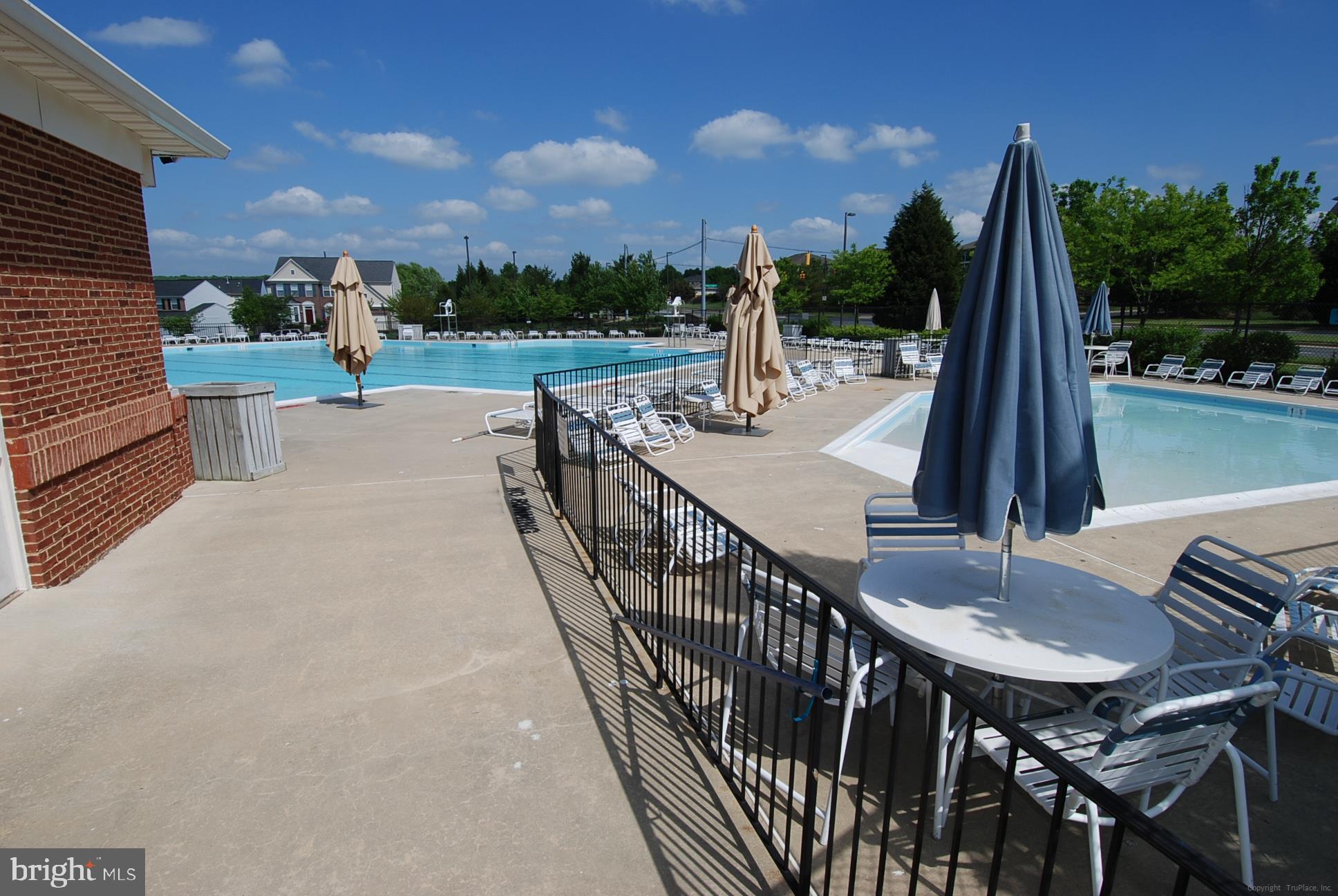12712 Found Stone Road, Unit 4206 Germantown, MD 20876 - Photo 44 of 58 a view of a patio with a table and chairs