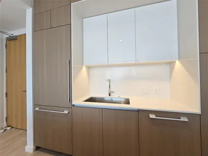 a kitchen with a sink and cabinets