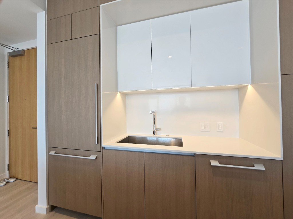 313 West 17th Street, Unit 1802 Austin, TX 78701 - Photo 11 of 24 a kitchen with a sink and cabinets