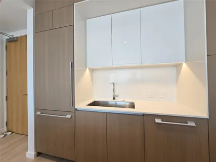 a kitchen with a sink and a refrigerator