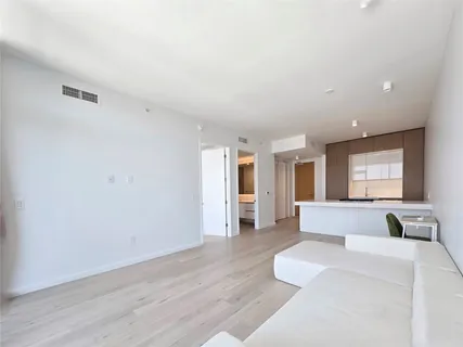 a living room with furniture and large window