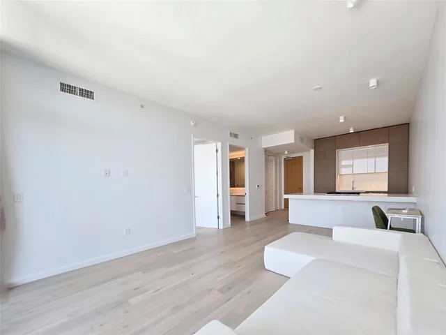 a living room with furniture and large window