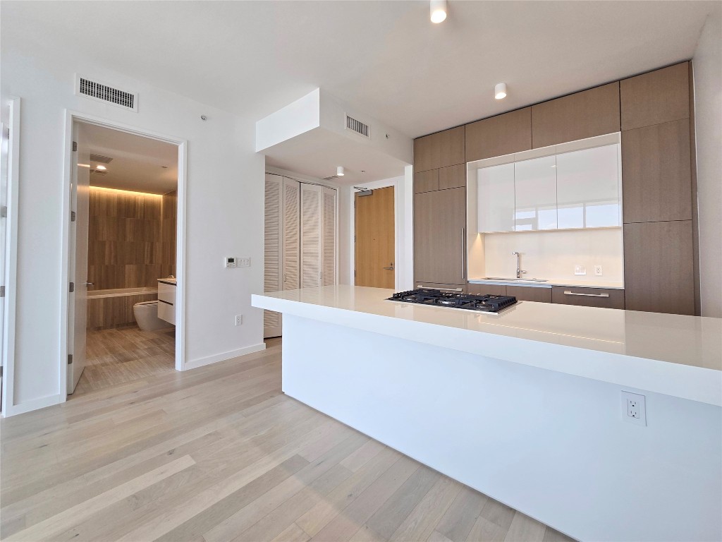 313 West 17th Street, Unit 1802 Austin, TX 78701 - Photo 17 of 24 a living room with stainless steel appliances kitchen island granite countertop furniture and a large window