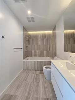 a bathroom with a bathtub a sink and a toilet