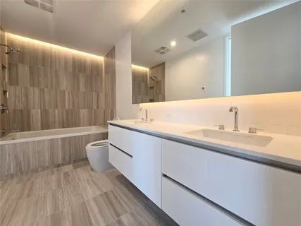 a bathroom with a sink and a large mirror
