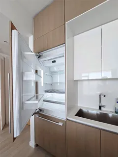 a kitchen with a refrigerator and a sink