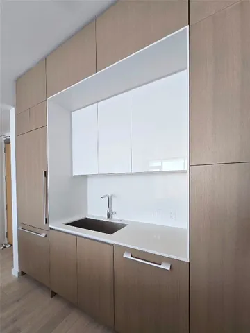 a kitchen with a sink and cabinets