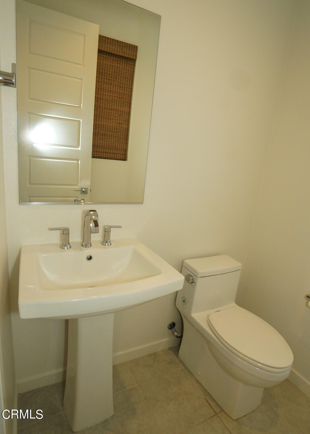 1063 Canal Street Oxnard, CA 93035 - Photo 11 of 32 a bathroom with a sink a toilet and mirror