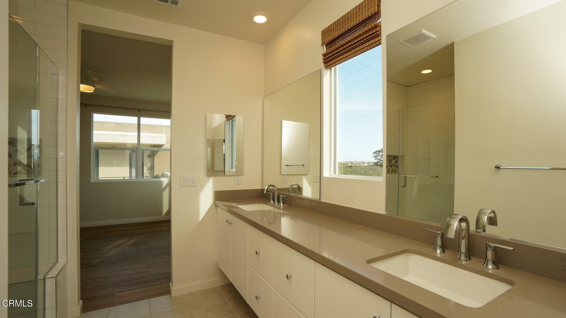 1063 Canal Street Oxnard, CA 93035 - Photo 16 of 32 a bathroom with a double vanity sink and a mirror